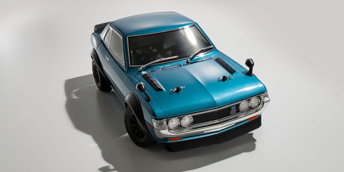 Kyosho official overhead/front-quarter view of the finished turquoise Celica GT and vintage wheels.
