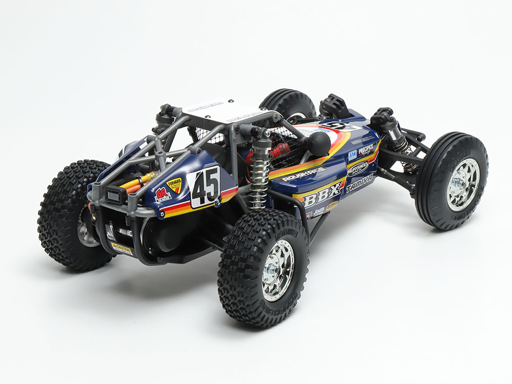 Tamiya official alternate assembled BBX view: six-piece panels, driver, cage and netting form the finished model.